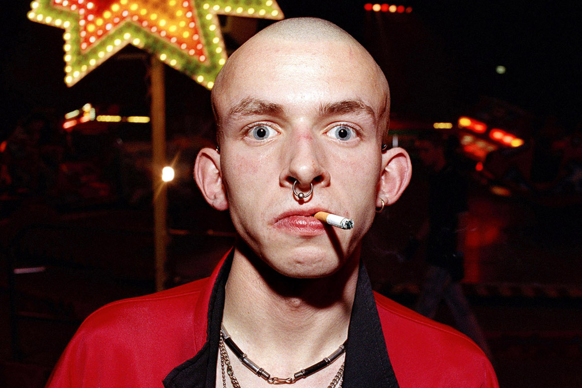 Nederland, Amsterdam, 16 december 2007
Rokende gabber op de Thunderdome in de Rai, Amsterdam.
foto/copyright: Martijn van de Griendt/Hollandse Hoogte
Martijn van de Griendt (1970) is a documentary photographer. Since the turn of the 1990s he has been fascinated by the  Western society he lives in, especially youth culture. His style is characterized by crisp, bright colours, but they also have a raw element and a ‘close to the skin’ feel. He has also taken photos of pop music heroes such as Eminem, Dr. Dre, Snoop Dogg, Lenny Kravitz and Alicia Keys.
His new book Smokin’ Boys Smokin’ Girls is a selection taken from his youth work. (ISBN 978 90 5330 633 8)

Martijn van de Griendt also published Hassan & Hoessein, a hard-hitting report on the lives of a set of Moroccan-Dutch twins, seen through a sympathetic lens (Mets & Schilt, 2005).